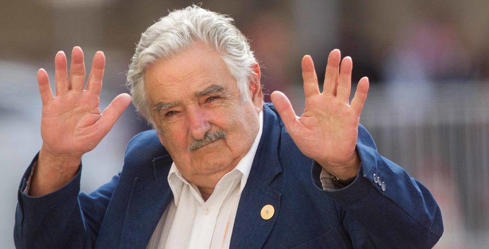 Uruguay's president Jose Mujica waves at the press upon his arrival at La Moneda presidential palace in Santiago, on March 10, 2014.