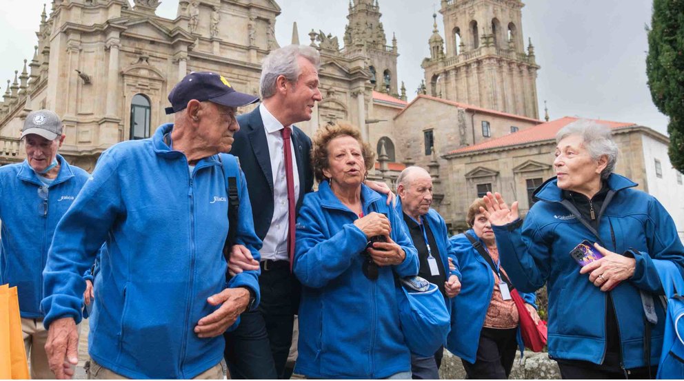 O presidente da Xunta, Alfonso Rueda, sauda ás persoas participantes no Programa Reencontros con Galicia. Escalinata exterior do Mosteiro de San Martiño Pinario, 18/10/23.