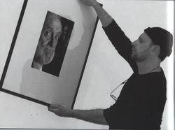 El artista contemplando uno de sus retratos