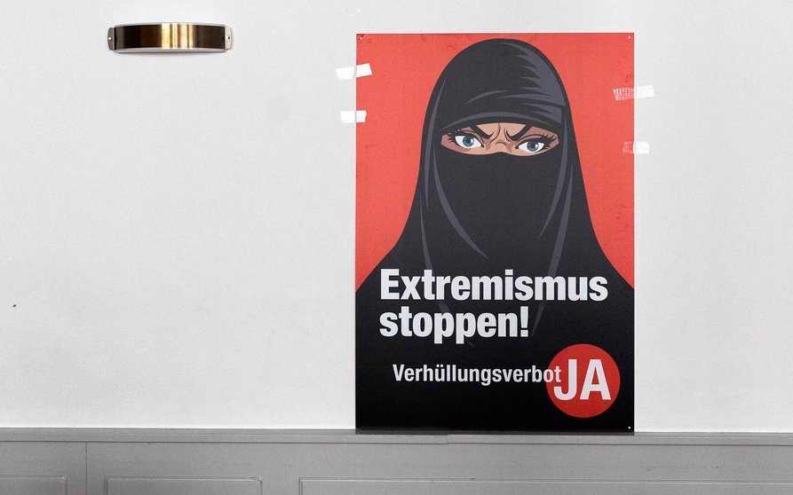 Bern (Switzerland), 07/03/2021.- A poster 'Stop Extremism' hangs on a wall at the meeting place of the supporters of the Burqa Ban initiative, in Bern, Switezrland, 07 March 2021. Swiss citizens vote on a proposal to prohibit the concealment of one's face in the public space. Led by right-wing groups, the so-called 'anti-burqa' initiative provides for a ban on the wearing of the niqab, as well as other non-religious forms of face concealment. (Suiza) EFE/EPA/PETER KLAUNZER
